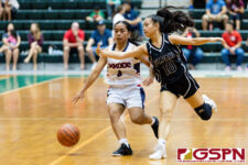 St. Paul Warrior Kirsten Silva reaches in for a steal on Okkodo Bulldog Racquel Camacho. (Photo by Michael Blas)