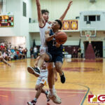 St. Paul Warriors Jahmar White flies towards the basket while Matt Fergurgur stands to contests. (Photo by Michael Blas)