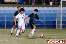 JFK Islander defender Alexander Chambach succesfully regains posession of the ball over Harvest Eagle Gye Baek Kim. (Photo by Michael Blas)