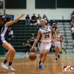 St. Paul Warriors Niah Siguenza dribbles past the defense for a shot in the paint. (Photo by Michael Blas)