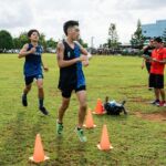 St. Paul Warriors Jacob Miranda runs in third overall with a time of 18:10.00 and Harvest Eagle Keanu Hada finishes first for his team with a time of 18:11.00. (Photo by Michael Blas)